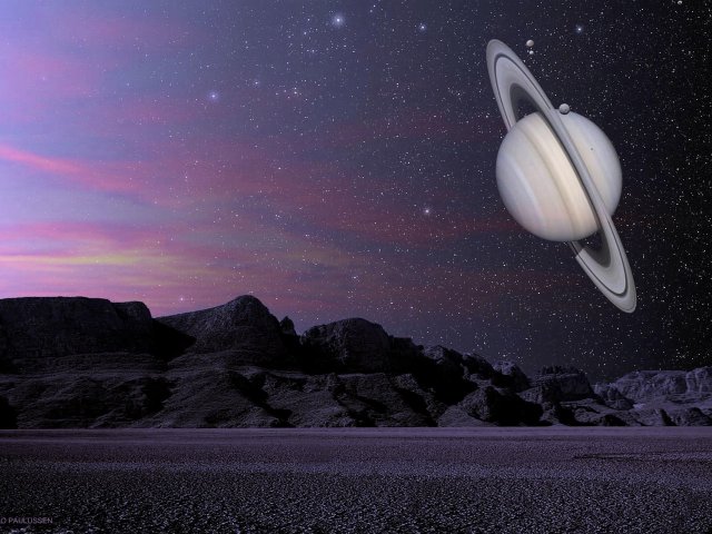 Morgen über Titan. Der Saturn und einige seiner Monde zeigen sich am Himmel.